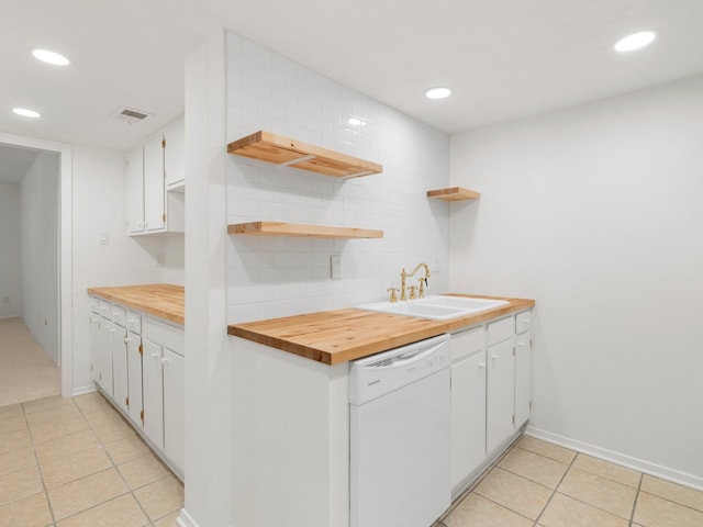 kitchen with white cabinetry, white dishwasher, light tile floors, sink, and tasteful backsplash