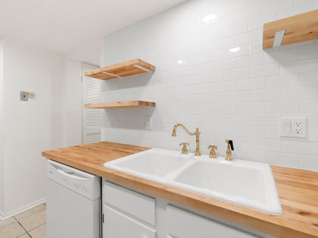 kitchen featuring tile walls, light tile floors, white cabinets, sink, and white dishwasher