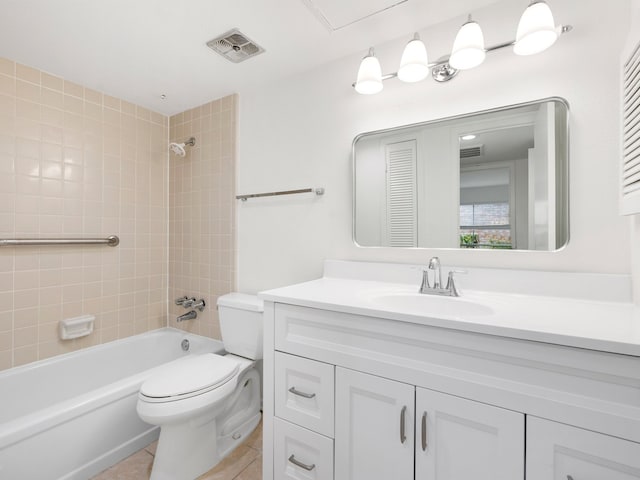 full bathroom featuring tile floors, toilet, vanity with extensive cabinet space, and tiled shower / bath