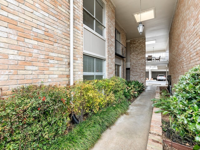 view of exterior entry with a balcony