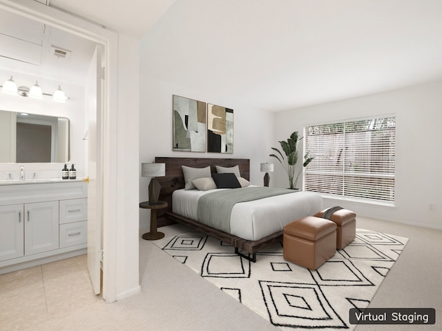 bedroom with ensuite bath, sink, and light tile floors