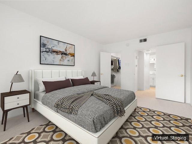 bedroom featuring connected bathroom, a closet, and carpet floors