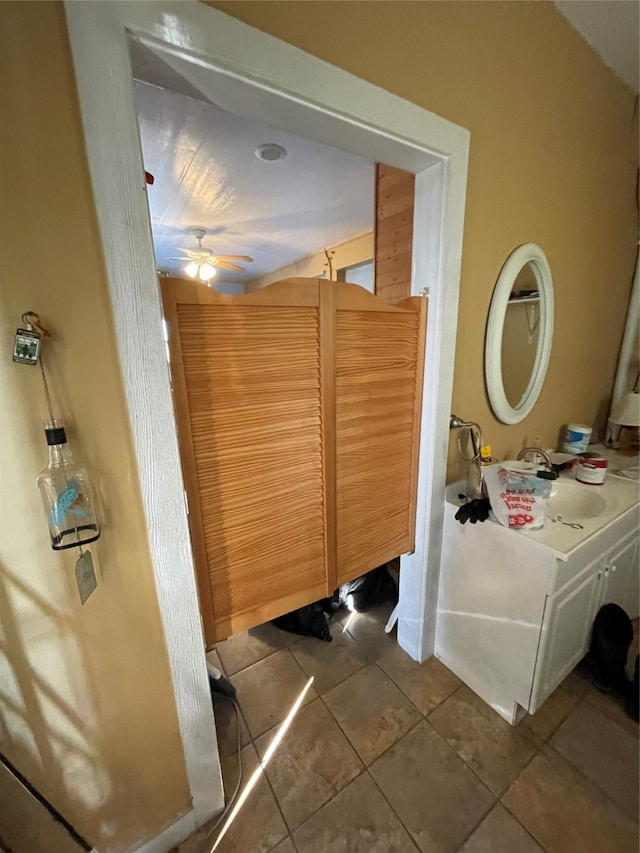 bathroom with ceiling fan, tile patterned floors, and sink