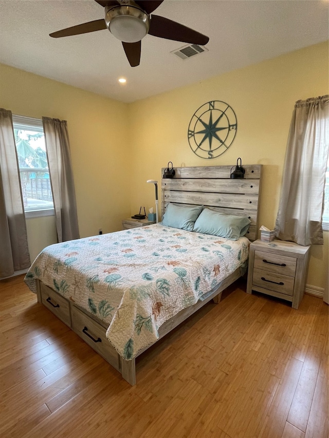 bedroom with ceiling fan and light wood-type flooring