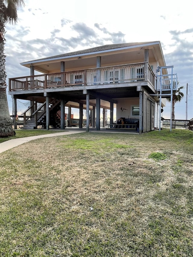 rear view of house featuring a yard