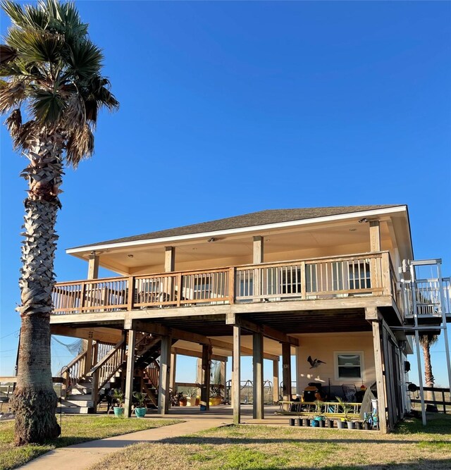 rear view of property featuring a deck