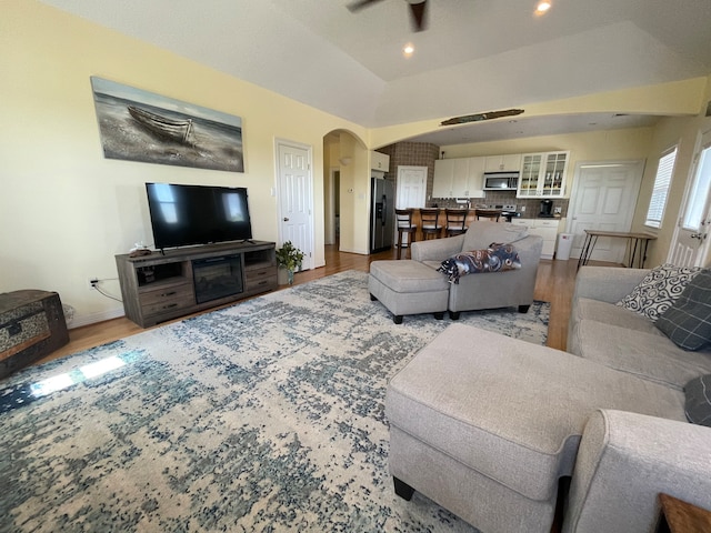 living room with wood-type flooring and lofted ceiling