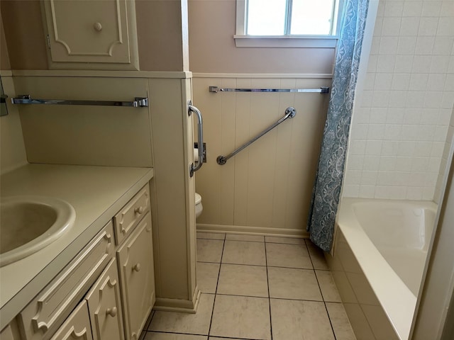 full bathroom featuring vanity, shower / bath combo with shower curtain, toilet, and tile patterned floors