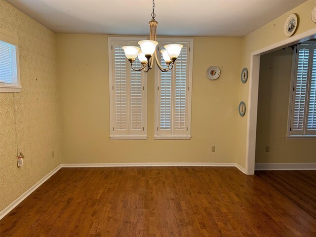 713 Sarah Jo St, La Grange, TX 78945 - spare room featuring wood finished floors, a chandelier, and baseboards