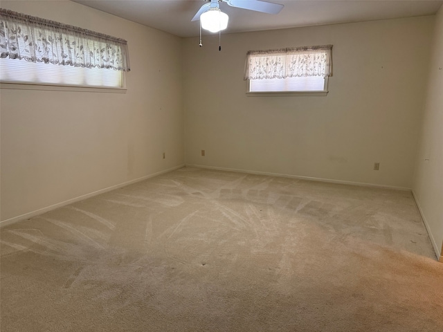 empty room featuring carpet floors and ceiling fan