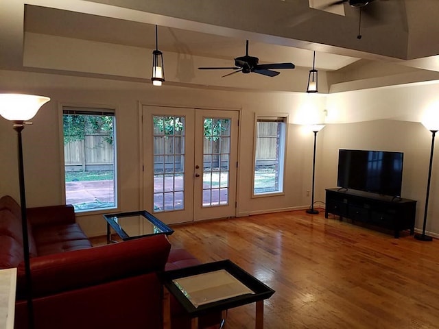 living room featuring french doors, wood-type flooring, and ceiling fan