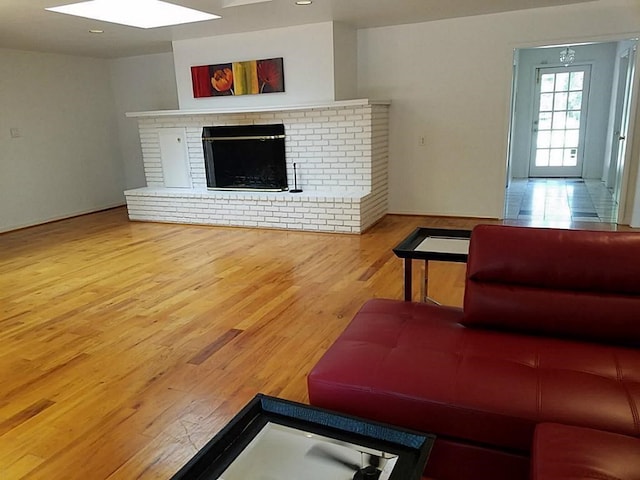 living room featuring a fireplace and light wood-type flooring