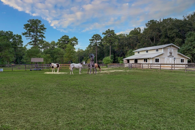 view of yard featuring an outdoor structure and a rural view