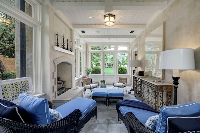 sunroom / solarium featuring beam ceiling