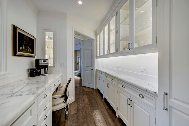 office with dark wood-type flooring and ornamental molding