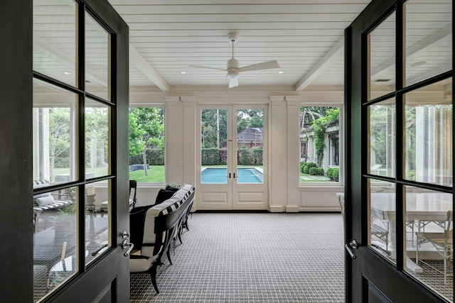 sunroom featuring ceiling fan, french doors, and beamed ceiling