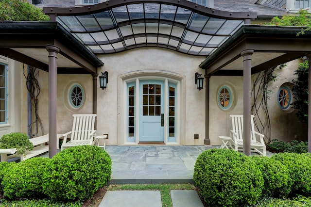 view of exterior entry with french doors and a patio