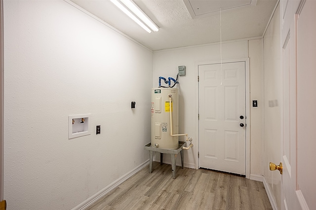 washroom with washer hookup, a textured ceiling, electric water heater, and light hardwood / wood-style floors