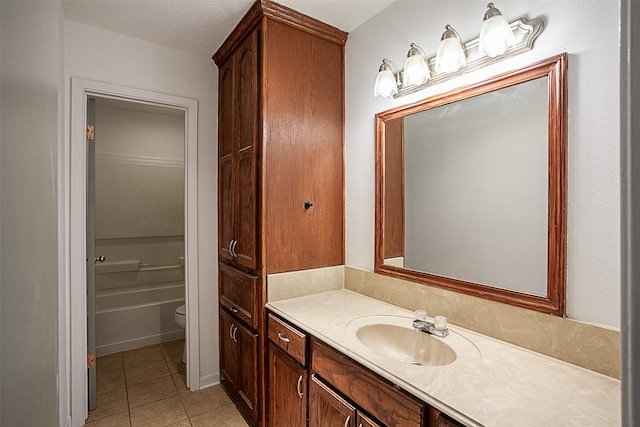 full bathroom with toilet, shower / bathing tub combination, tile flooring, a textured ceiling, and vanity