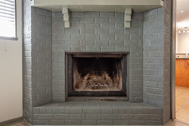 room details with a fireplace and tile floors