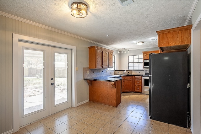 kitchen featuring french doors, kitchen peninsula, light tile floors, appliances with stainless steel finishes, and backsplash