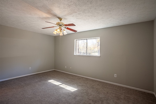 empty room featuring ceiling fan, carpet floors, and a textured ceiling