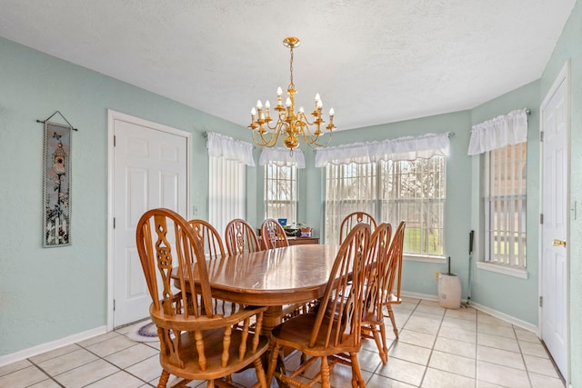 dining room featuring light tile patterned floors, a textured ceiling, and a notable chandelier