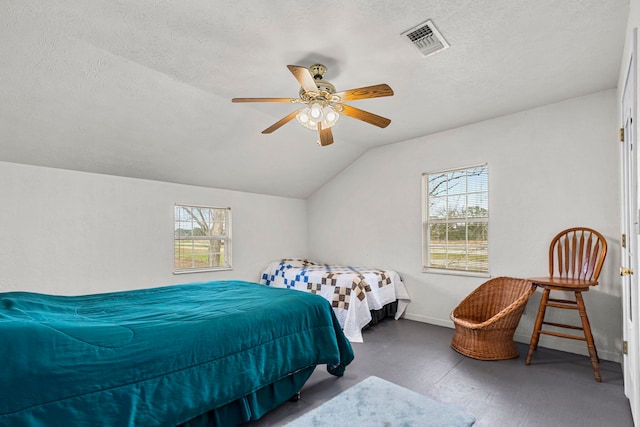 bedroom with a textured ceiling, ceiling fan, and lofted ceiling