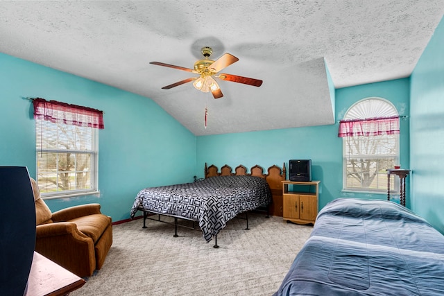 bedroom with carpet flooring, ceiling fan, lofted ceiling, and a textured ceiling