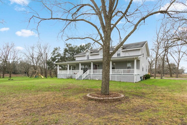 country-style home with a playground, a front lawn, and a porch