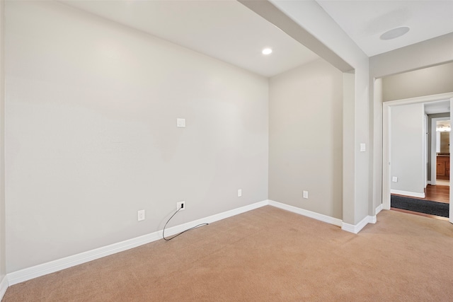 unfurnished room featuring light colored carpet