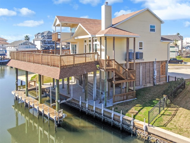 back of property featuring a water view and cooling unit