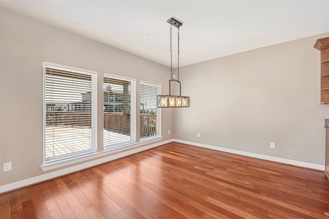 unfurnished dining area featuring hardwood / wood-style flooring