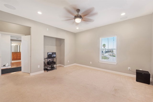 unfurnished bedroom featuring light carpet and ceiling fan