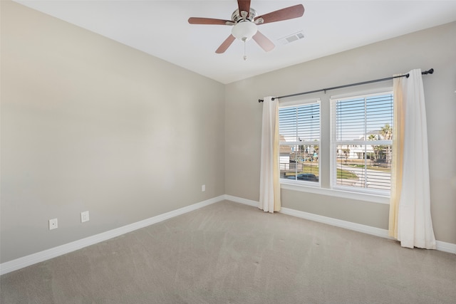 carpeted spare room with ceiling fan