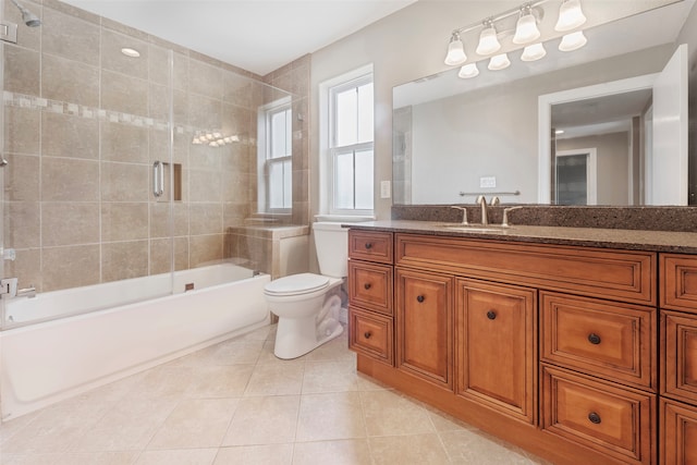 full bathroom with bath / shower combo with glass door, vanity, toilet, and tile patterned flooring