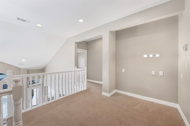 corridor featuring light colored carpet