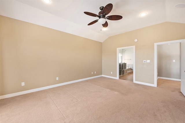 carpeted empty room featuring vaulted ceiling and ceiling fan