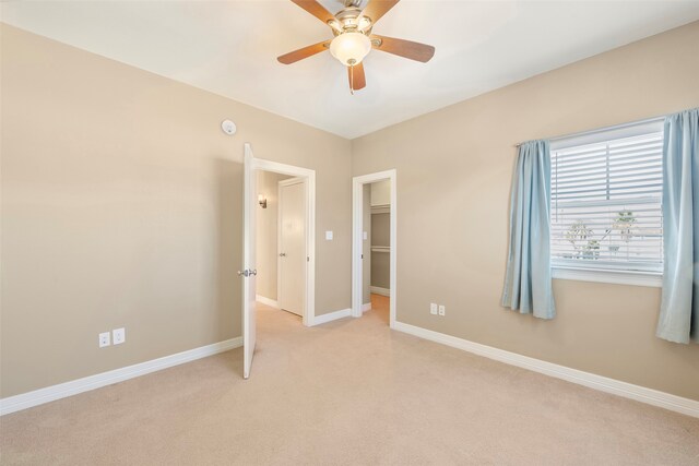 unfurnished bedroom featuring ceiling fan and light colored carpet