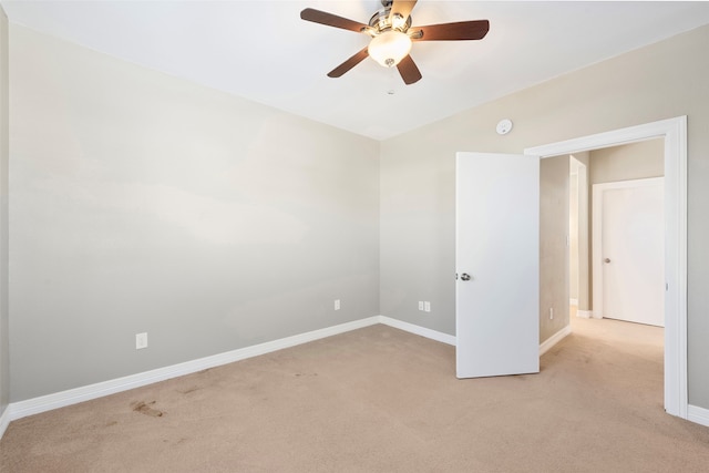 carpeted empty room featuring ceiling fan and vaulted ceiling