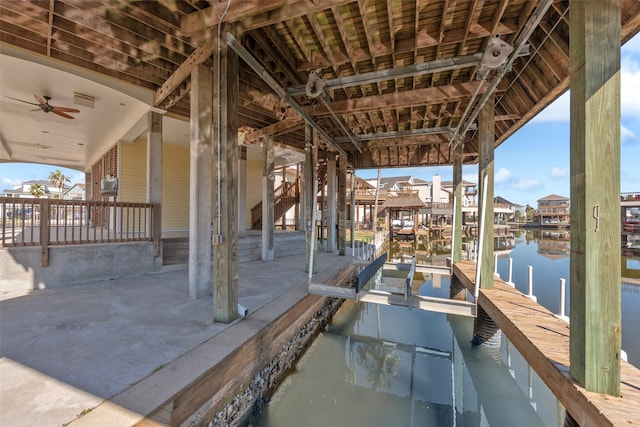 exterior space with a water view and a dock