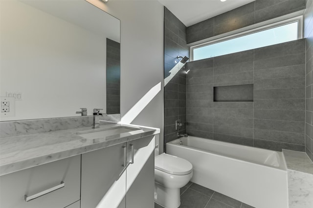 full bathroom with tile patterned floors, toilet, vanity, and tiled shower / bath