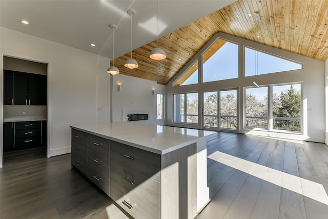 kitchen with a center island, wooden ceiling, dark wood-type flooring, high vaulted ceiling, and decorative light fixtures