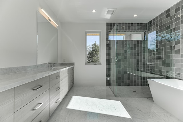 bathroom with vanity and independent shower and bath