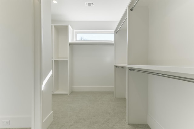 spacious closet featuring light carpet