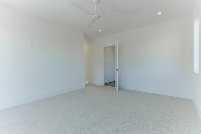 spare room featuring ceiling fan and light colored carpet