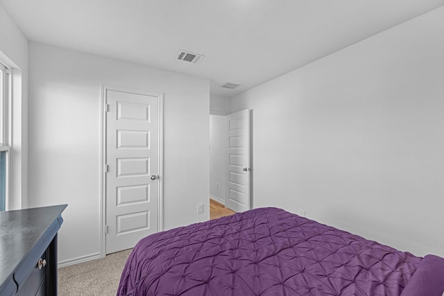 bedroom featuring light colored carpet