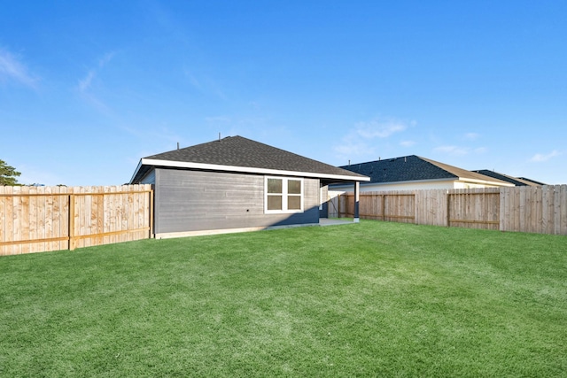 rear view of house featuring a lawn