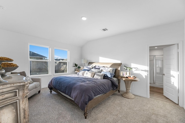 bedroom with carpet floors and lofted ceiling