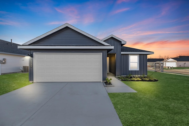 view of front of house with a yard and a garage